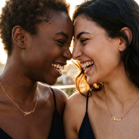 Thumbnail for Two women wearing the Minimalist Name Necklace in gold, the names Amara and Nour | SKU: minimalistnn-gold