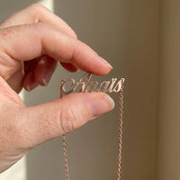 Thumbnail for Minimalist Name Necklace in rose gold pendant held between two fingertips showing its true size, the name Anais | SKU: minimalistnn-rosegold