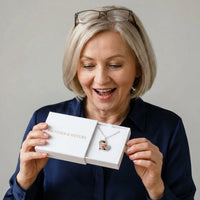 Thumbnail for Woman in her fifties discovering her grandson's photo in the silver heart necklace, in the gift box | SKU: TPH-HRTN-SILVER