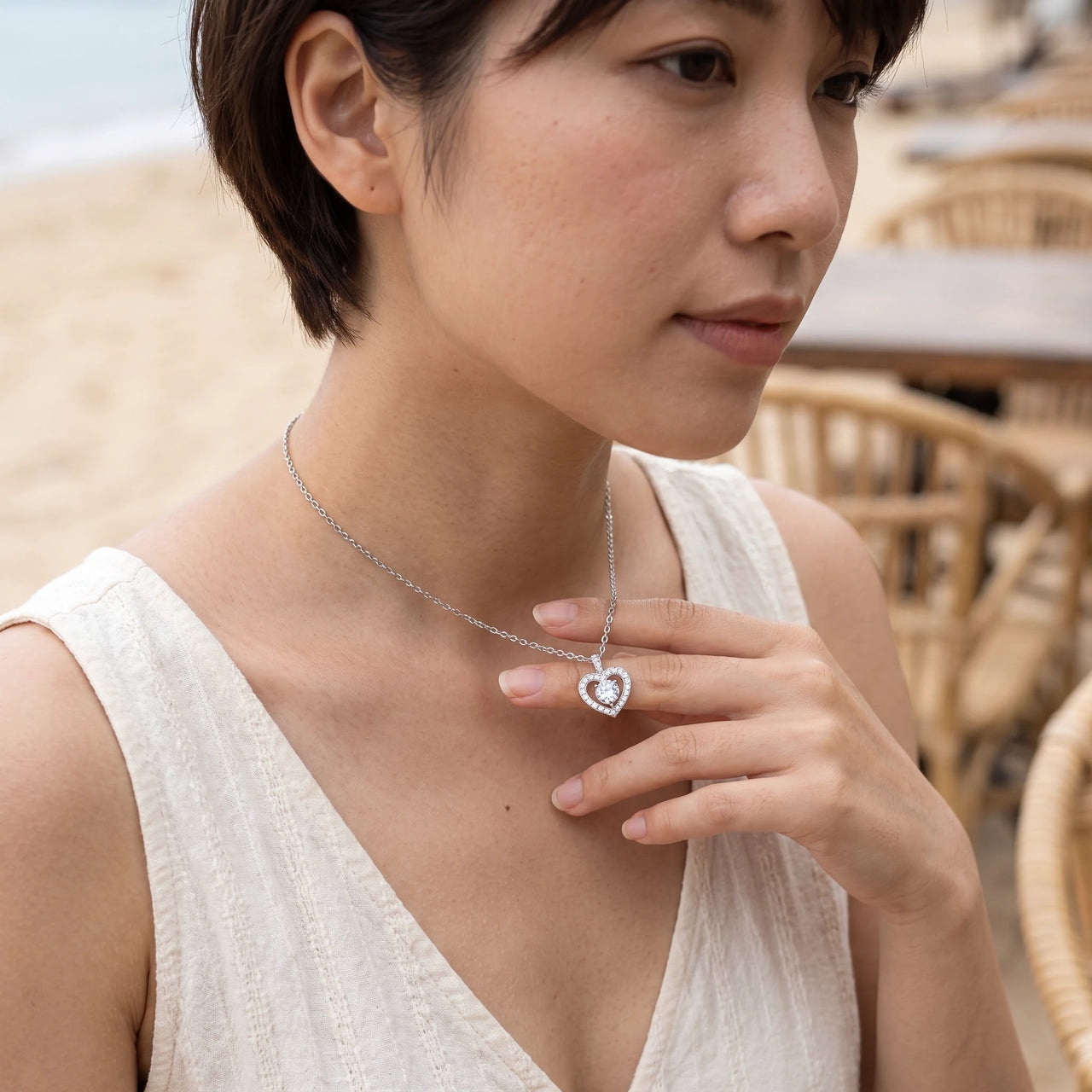 Woman gently touching her silver necklace | SKU: 505744