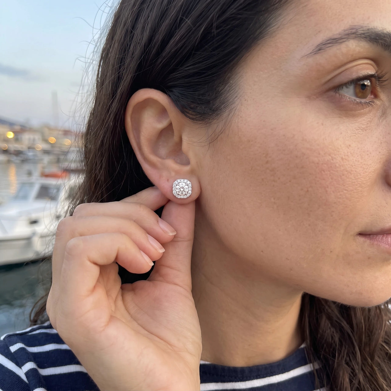 Woman gently touching her silver stud earrings | SKU: 505263