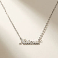 Thumbnail for Minimalist Name Necklace in silver laid flat, cursive cut-metal script, the name Naima | SKU: minimalistnn-silver