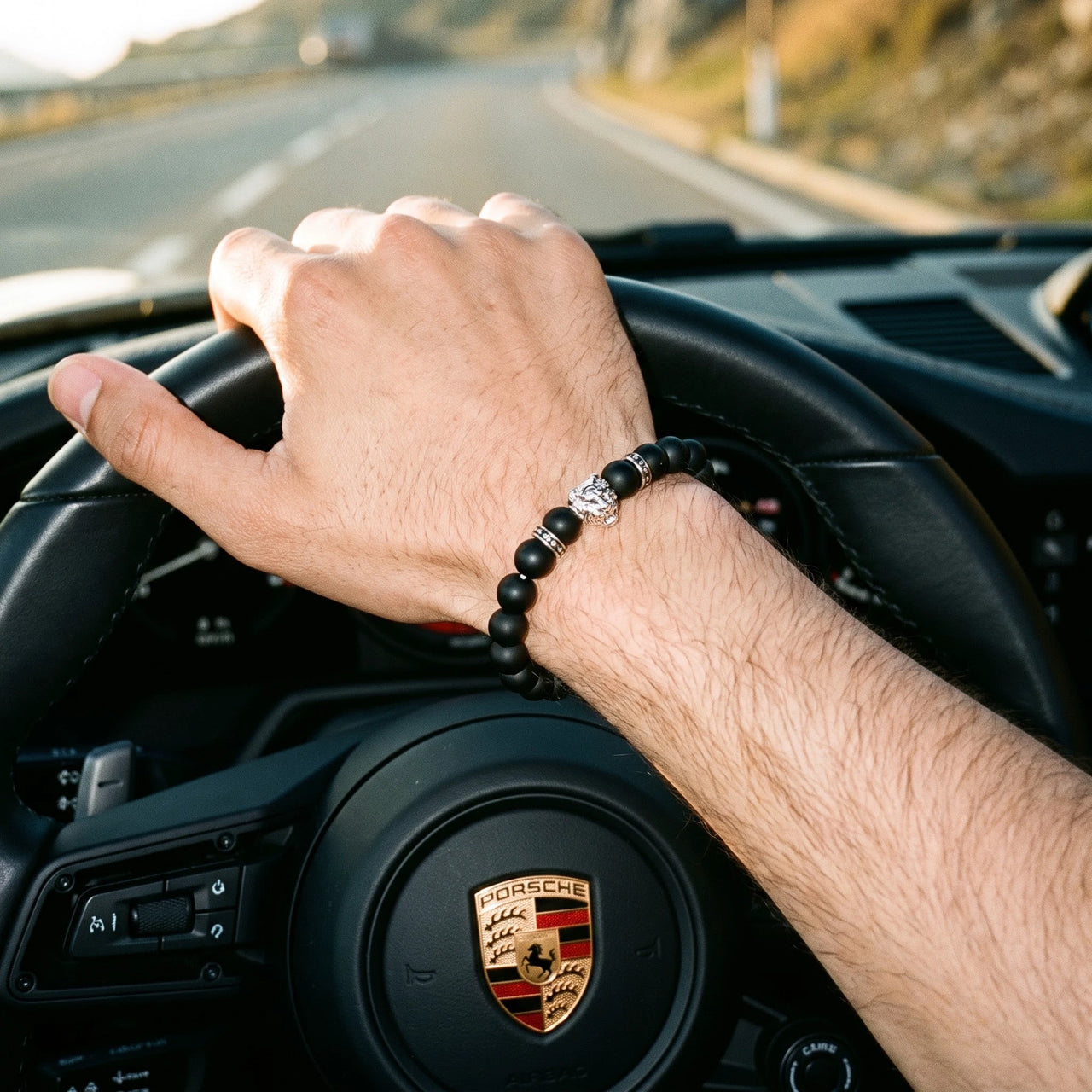 White Gold Lion & Black Stones Bracelet – worn at the steering wheel of a luxury car | Brother & Sisters | SKU: 20712286-silver-XS-14-15, 20712286-silver-S-16-17, 20712286-silver-M-18-19, 20712286-silver-L-20-21, 20712286-silver-XL-22-23